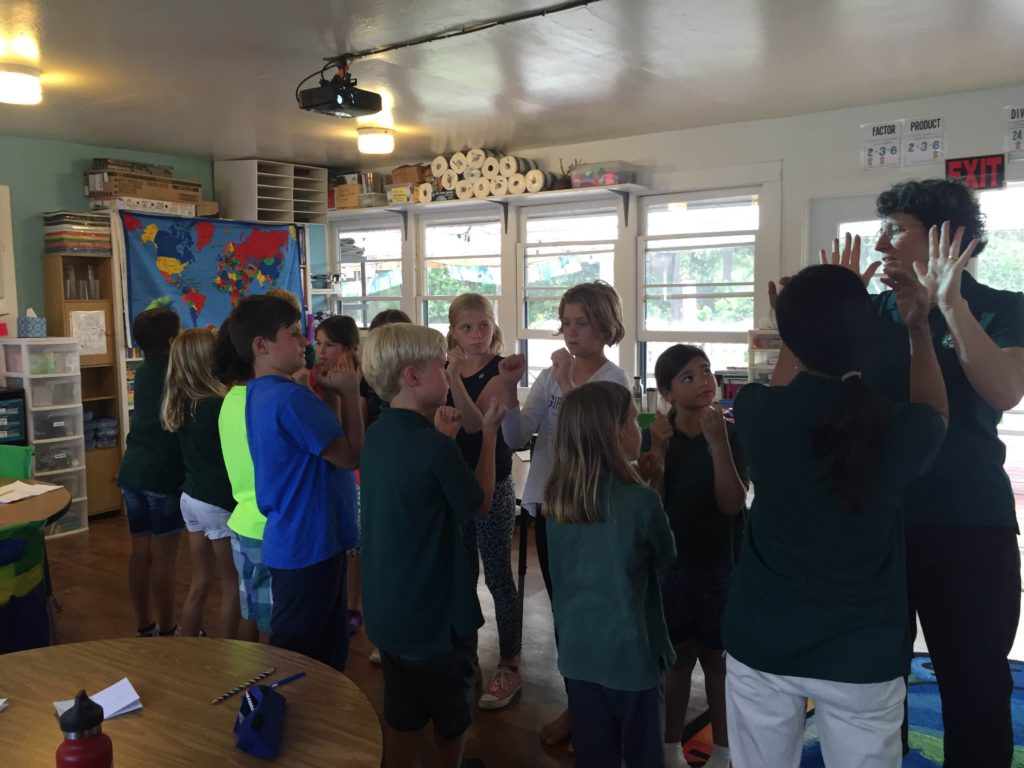 Waimea Country School students take an active "brain break" during their conflict resolution training workshop with WHMC.